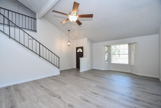 15827 Tammany Ln, Houston, TX 77082 - unfurnished living room featuring beamed ceiling, baseboards, stairs, wood finished floors, and a ceiling fan
