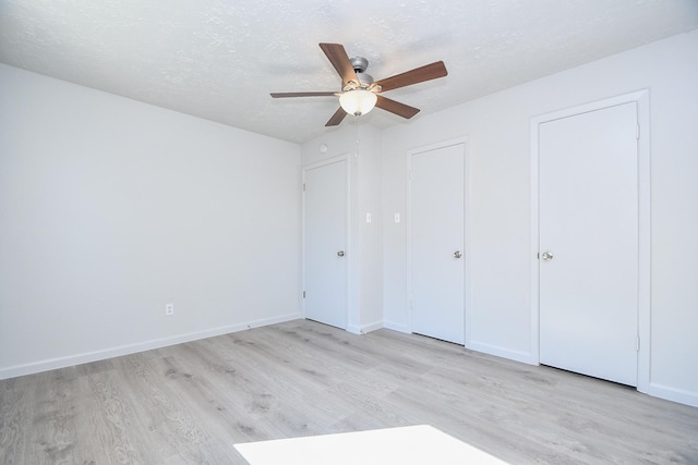 15827 Tammany Ln, Houston, TX 77082 - unfurnished bedroom featuring a ceiling fan, a textured ceiling, baseboards, and wood finished floors