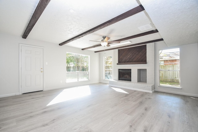 15827 Tammany Ln, Houston, TX 77082 - unfurnished living room with baseboards, wood finished floors, beam ceiling, and a textured ceiling