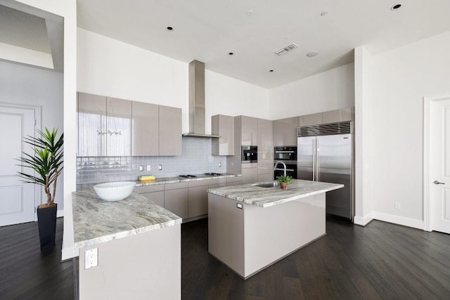 1409 Post Oak Blvd Unit 2702, Houston, TX 77056 - kitchen with wall chimney range hood, backsplash, visible vents, modern cabinets, and appliances with stainless steel finishes