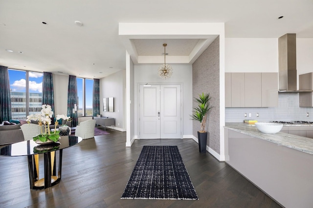 1409 Post Oak Blvd Unit 2702, Houston, TX 77056 - foyer entrance with a tray ceiling, a high ceiling, baseboards, and dark wood-style floors