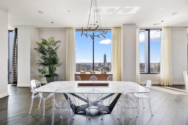 1409 Post Oak Blvd Unit 2702, Houston, TX 77056 - dining area featuring a city view, wood finished floors, an inviting chandelier, and baseboards
