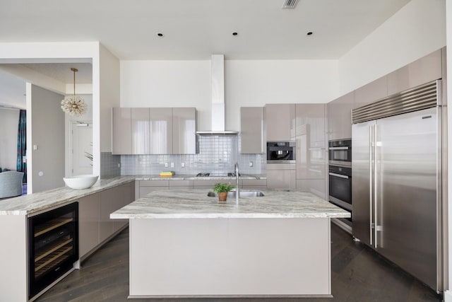 1409 Post Oak Blvd Unit 2702, Houston, TX 77056 - kitchen featuring wine cooler, wall chimney range hood, appliances with stainless steel finishes, and modern cabinets