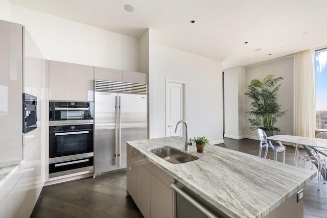 1409 Post Oak Blvd Unit 2702, Houston, TX 77056 - kitchen with a warming drawer, dark wood-type flooring, modern cabinets, stainless steel appliances, and a sink