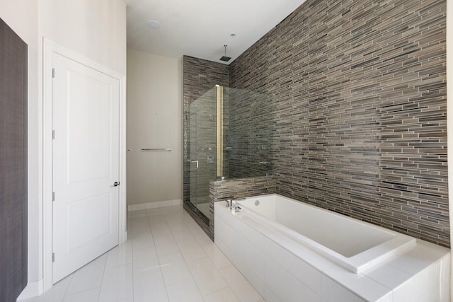 1409 Post Oak Blvd Unit 2702, Houston, TX 77056 - bathroom featuring tile patterned floors, baseboards, a stall shower, and a garden tub