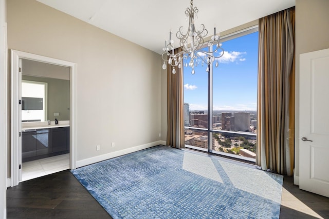 1409 Post Oak Blvd Unit 2702, Houston, TX 77056 - unfurnished dining area with wood finished floors, an inviting chandelier, baseboards, and a view of city