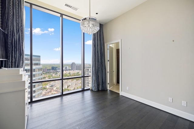 1409 Post Oak Blvd Unit 2702, Houston, TX 77056 - empty room with dark wood-style flooring, an inviting chandelier, a view of city, floor to ceiling windows, and visible vents