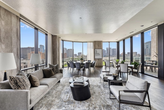 1409 Post Oak Blvd Unit 2702, Houston, TX 77056 - living room featuring floor to ceiling windows, a view of city, a textured ceiling, and wood finished floors