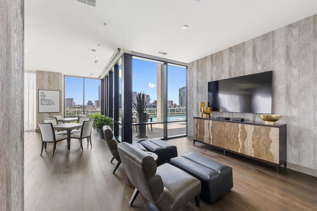 1409 Post Oak Blvd Unit 2702, Houston, TX 77056 - living room with visible vents, a wall of windows, and wood finished floors