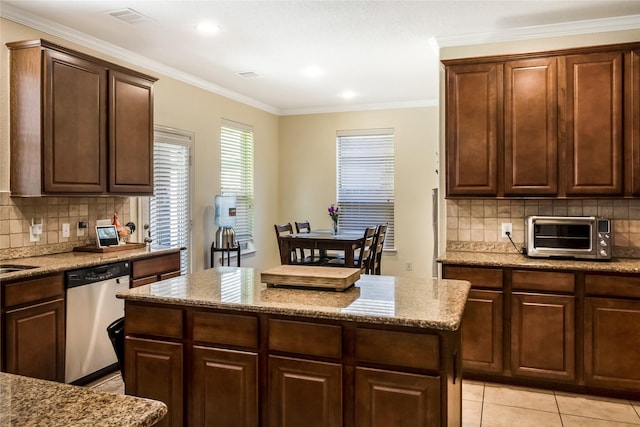 14711 E Ginger Spice Ct, Cypress, TX 77433 - kitchen with dishwasher, decorative backsplash, light stone countertops, a kitchen island, and crown molding