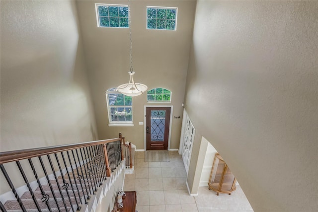 14711 E Ginger Spice Ct, Cypress, TX 77433 - foyer featuring healthy amount of natural light, light tile patterned flooring, baseboards, and a towering ceiling