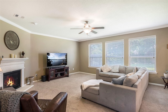 14711 E Ginger Spice Ct, Cypress, TX 77433 - living room with carpet flooring, a ceiling fan, a glass covered fireplace, crown molding, and plenty of natural light