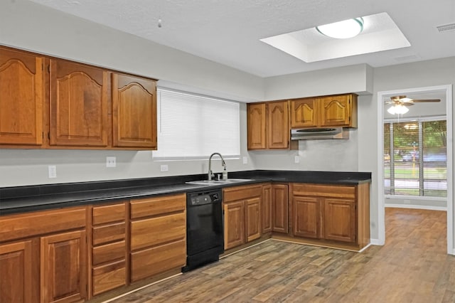 9611 Huntington Hill Dr, Houston, TX 77099 - kitchen featuring black dishwasher, a sink, dark countertops, and brown cabinetry