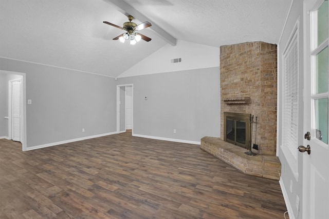 9611 Huntington Hill Dr, Houston, TX 77099 - unfurnished living room with a ceiling fan, dark wood-style floors, a brick fireplace, baseboards, and a textured ceiling