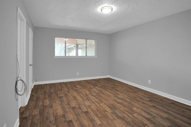 9611 Huntington Hill Dr, Houston, TX 77099 - spare room featuring dark wood finished floors, a textured ceiling, and baseboards