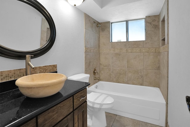 9611 Huntington Hill Dr, Houston, TX 77099 - bathroom featuring tasteful backsplash, toilet, shower / tub combination, vanity, and tile patterned floors