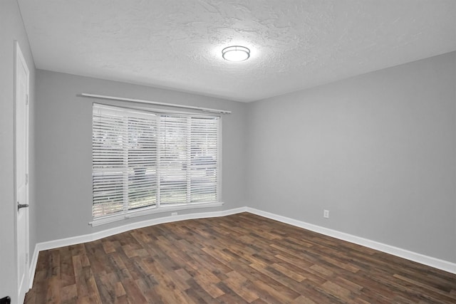 9611 Huntington Hill Dr, Houston, TX 77099 - spare room featuring dark wood-style flooring, baseboards, and a textured ceiling