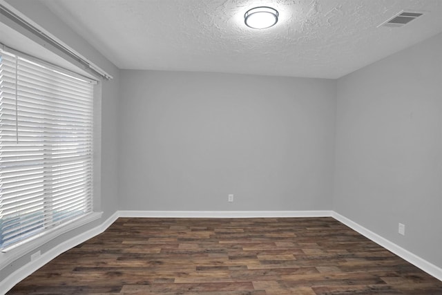 9611 Huntington Hill Dr, Houston, TX 77099 - unfurnished room with dark wood-type flooring, a textured ceiling, and baseboards
