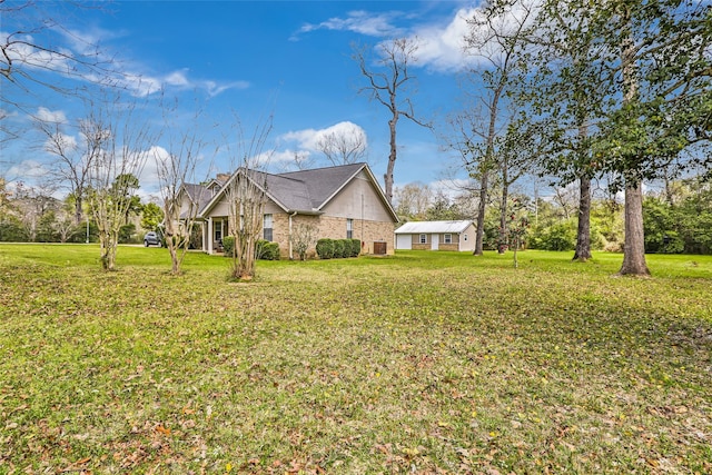 2585 State Highway 150, Coldspring, TX 77331 - view of side of home featuring a yard, an outbuilding, and brick siding