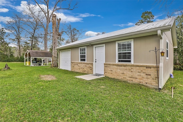 2585 State Highway 150, Coldspring, TX 77331 - rear view of property with brick siding, a lawn, and an attached garage