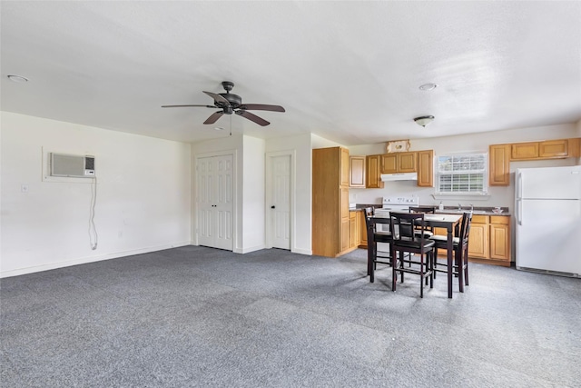 2585 State Highway 150, Coldspring, TX 77331 - kitchen featuring freestanding refrigerator, a wall mounted AC, under cabinet range hood, a ceiling fan, and carpet floors