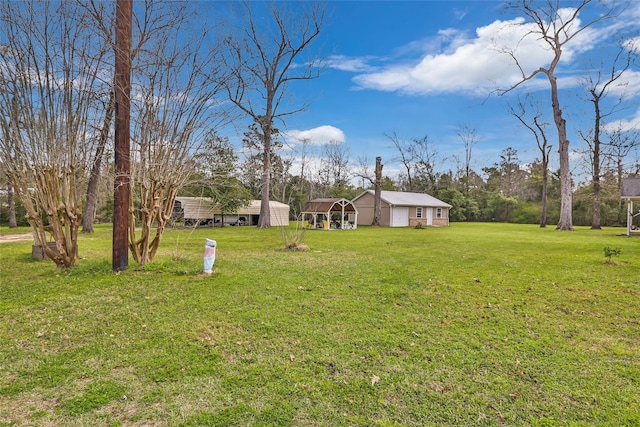 2585 State Highway 150, Coldspring, TX 77331 - view of green lawn with a detached carport