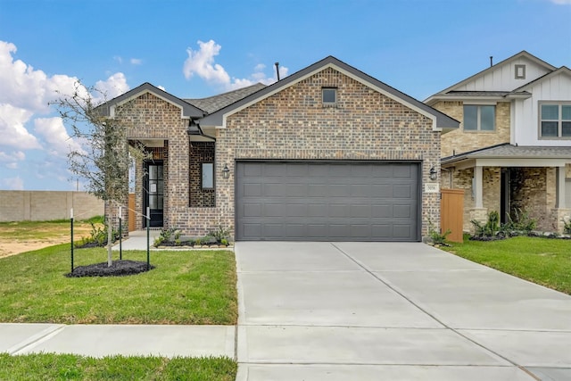 view of front of home featuring a front yard, an attached garage, fence, brick siding, and driveway
