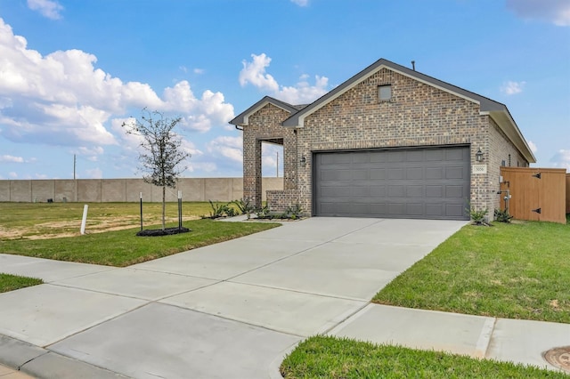 view of front facade featuring an attached garage, concrete driveway, a front yard, and brick siding