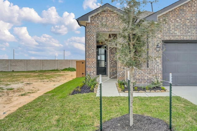 doorway to property with brick siding and a lawn