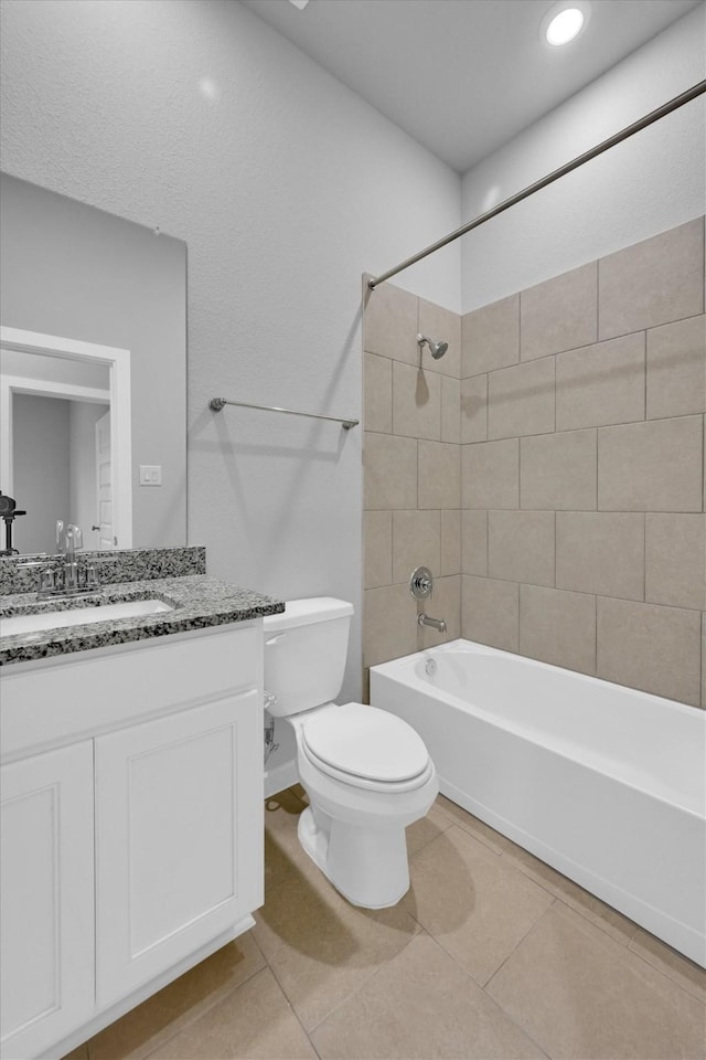 bathroom with tile patterned floors, toilet, shower / tub combination, and vanity