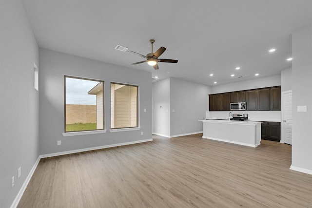unfurnished living room featuring light wood-type flooring, baseboards, recessed lighting, visible vents, and ceiling fan