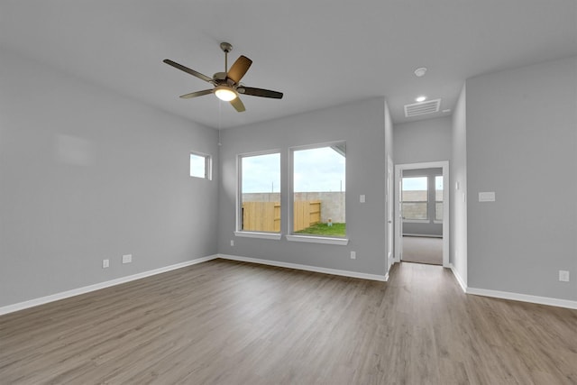 empty room featuring baseboards, recessed lighting, visible vents, ceiling fan, and wood finished floors