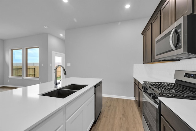 kitchen featuring light countertops, recessed lighting, a sink, and stainless steel appliances