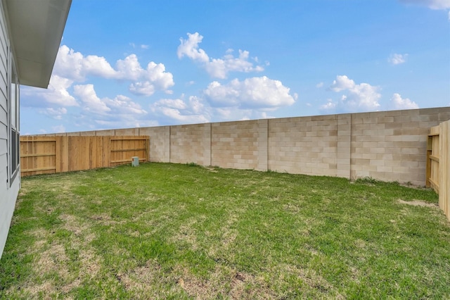 view of yard with a fenced backyard