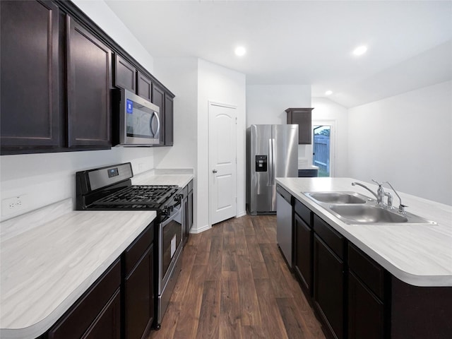 kitchen featuring recessed lighting, light countertops, a sink, dark wood-type flooring, and appliances with stainless steel finishes