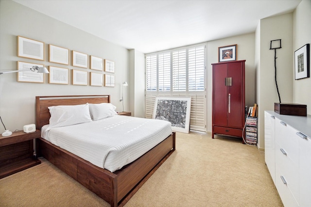 bedroom featuring light carpet