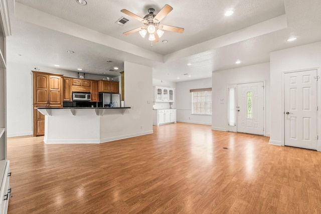 unfurnished living room featuring light wood finished floors, a ceiling fan, recessed lighting, and visible vents