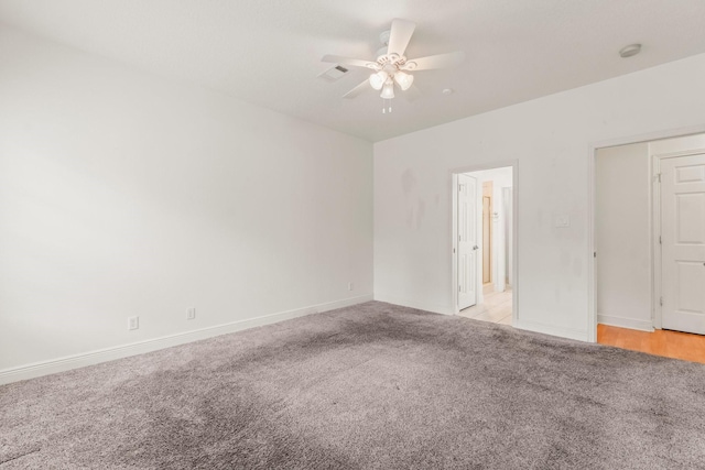 unfurnished room with baseboards, a ceiling fan, and light colored carpet