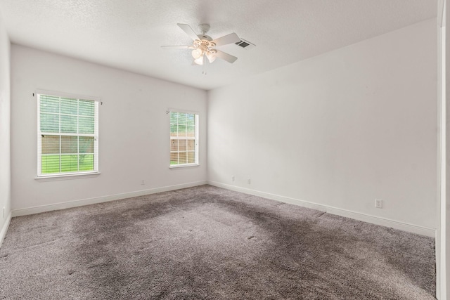 carpeted spare room with a ceiling fan, baseboards, visible vents, and a textured ceiling