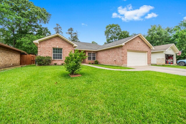104 Mccardell Ln, Livingston, TX 77351 - ranch-style house with an attached garage, driveway, a front lawn, and brick siding