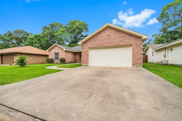 104 Mccardell Ln, Livingston, TX 77351 - ranch-style home with concrete driveway, brick siding, an attached garage, and a front yard