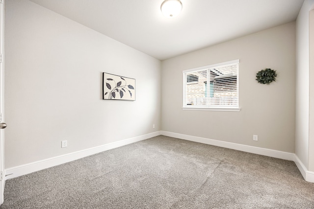 carpeted empty room with baseboards