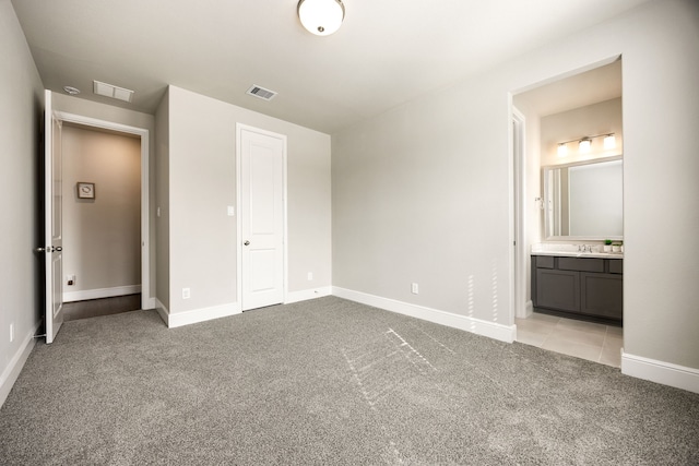unfurnished bedroom with light colored carpet, visible vents, and baseboards