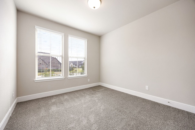 empty room with baseboards and carpet flooring
