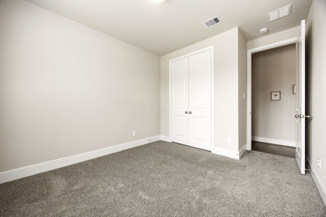 unfurnished bedroom with baseboards, visible vents, and carpet flooring