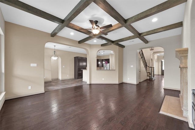 4510 Sanctuary Trails Dr, Spring, TX 77388 - unfurnished living room featuring coffered ceiling, ceiling fan, arched walkways, beam ceiling, and dark wood-style floors