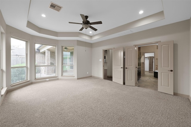4510 Sanctuary Trails Dr, Spring, TX 77388 - carpeted spare room with a tray ceiling, plenty of natural light, ceiling fan, baseboards, and recessed lighting