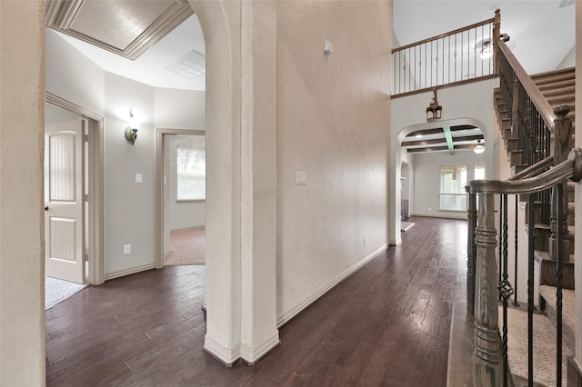 4510 Sanctuary Trails Dr, Spring, TX 77388 - hall with arched walkways, dark wood-style flooring, stairs, baseboards, and a towering ceiling