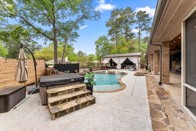 view of pool with a hot tub, a patio, a fenced in pool, and a fenced backyard