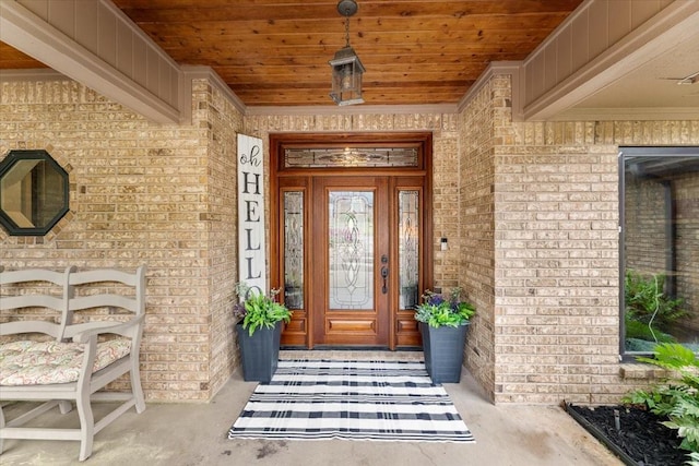 property entrance featuring brick siding